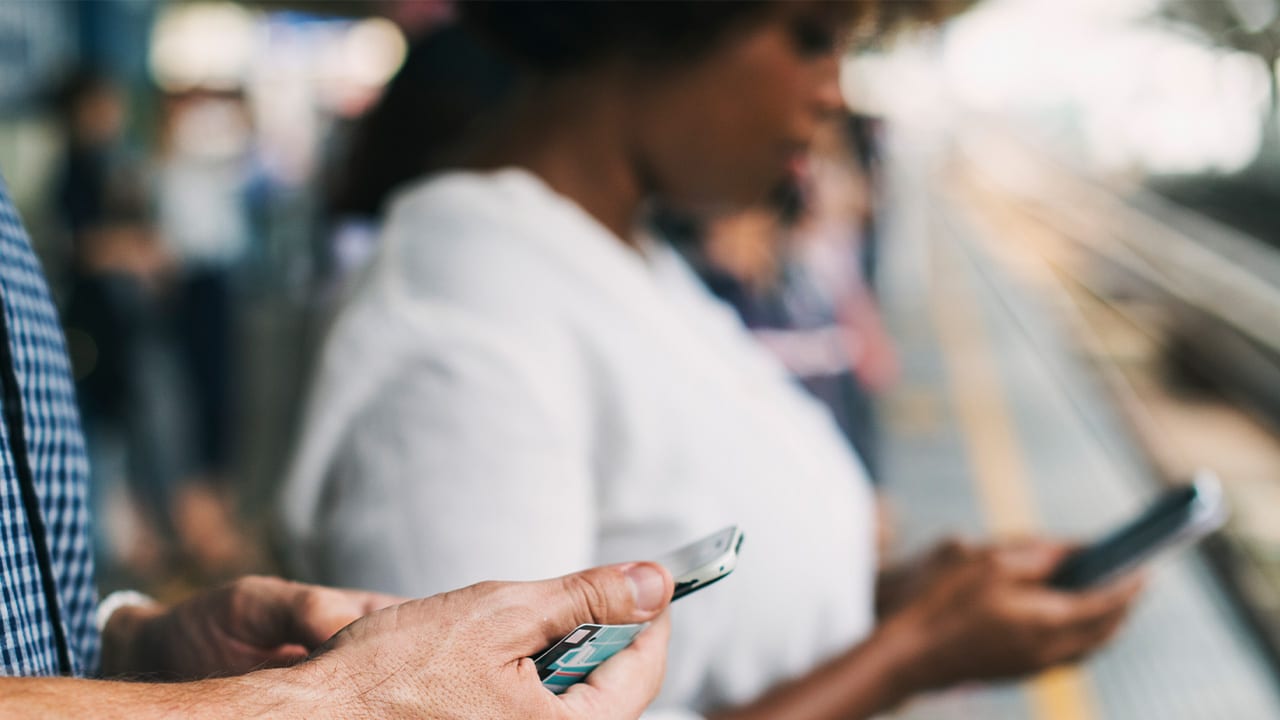 people at transtation using mobile devices